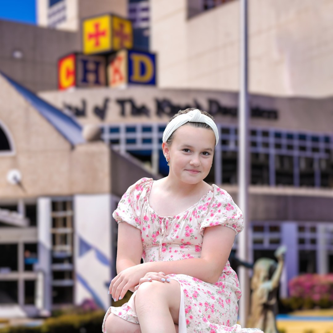 Girl posing in front of The King's Daughters building